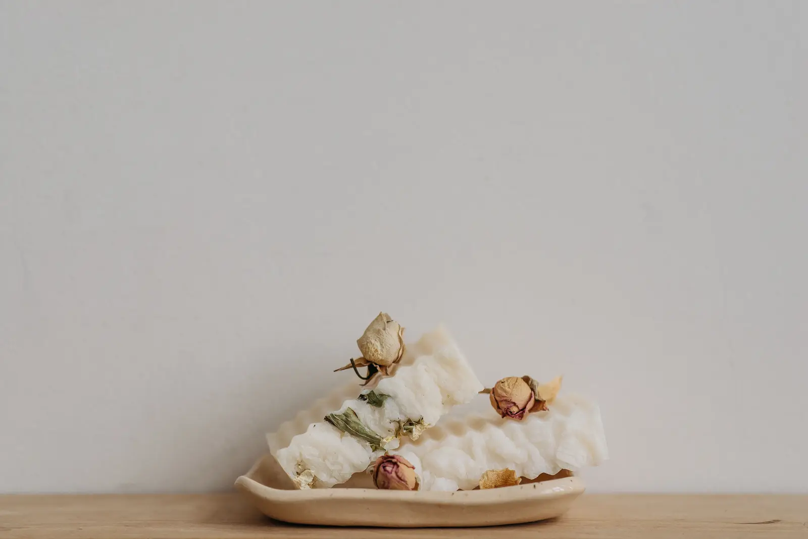 Handmade goat-milk soap on a wooden table