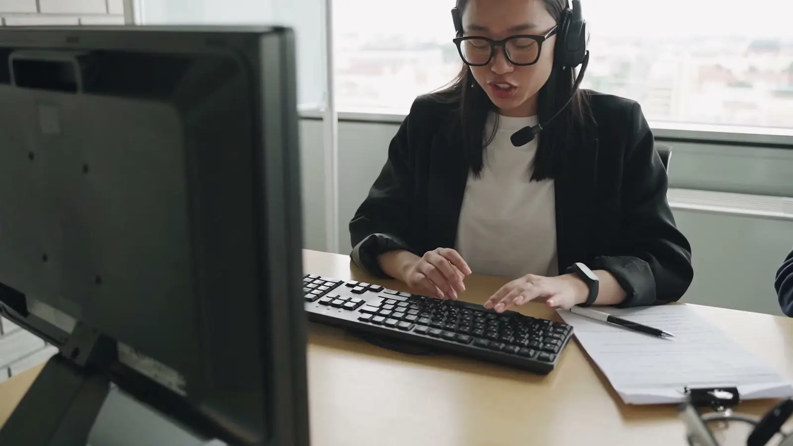 A customer service agent typing during a call