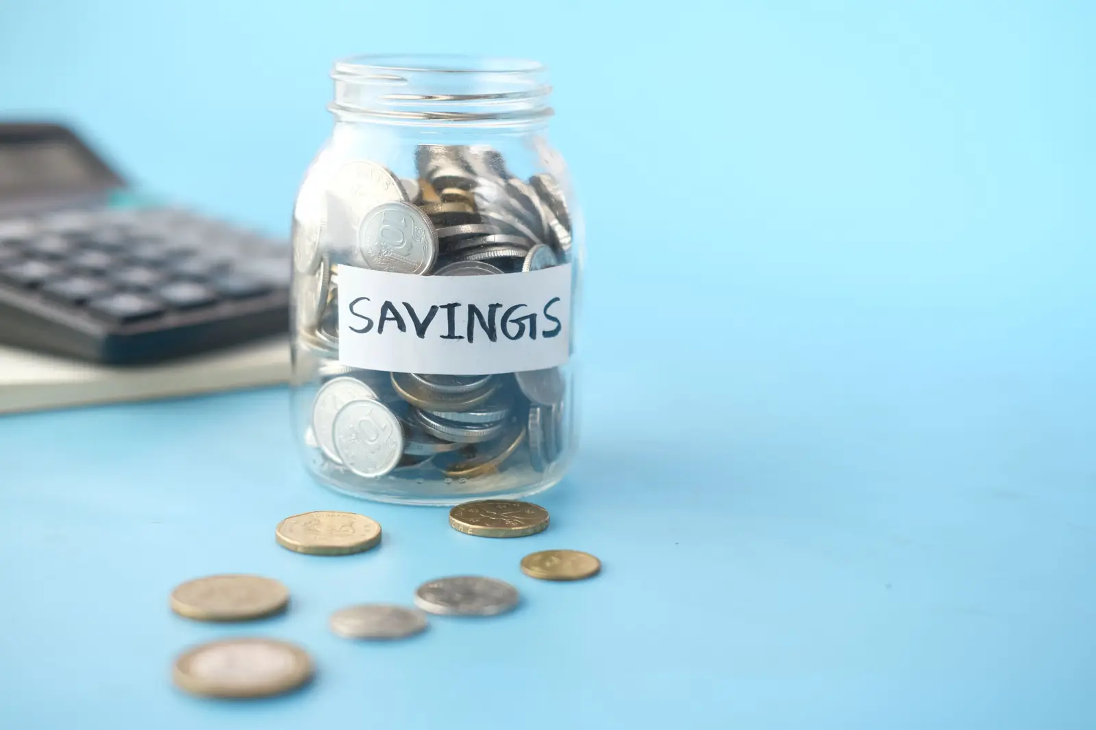 A coin-filled piggy bank and calculator