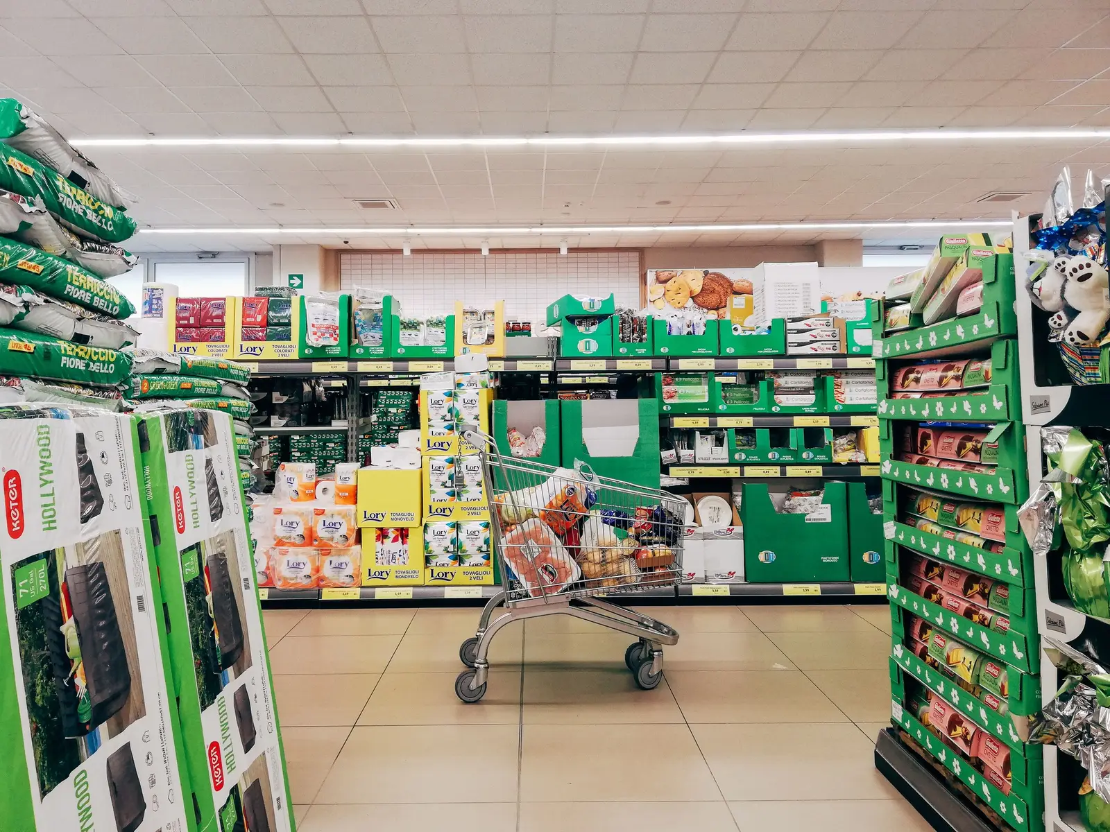 A shopping cart in a supermarket aisle